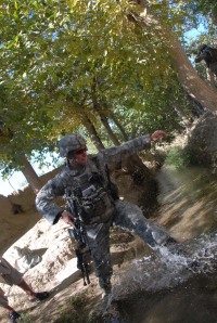 Charlie Company commander, CPT Duke Reim, attempts to jump over a small creek.