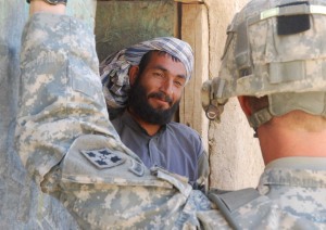 An Afghan man talks to the commander from Charlie Company